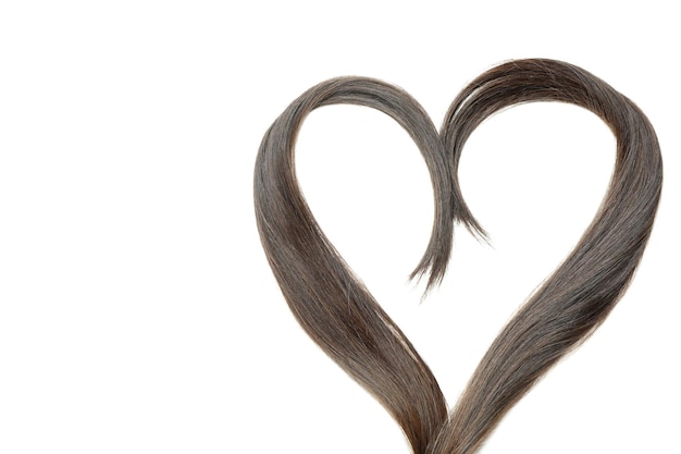 A lock of female hair in heart shape isolated on white background