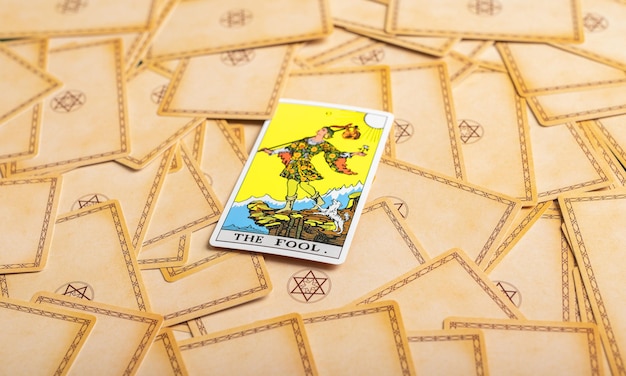 Lodz Poland April 15 2023 The fool arcana on tarot cards deck background Taro divination concept