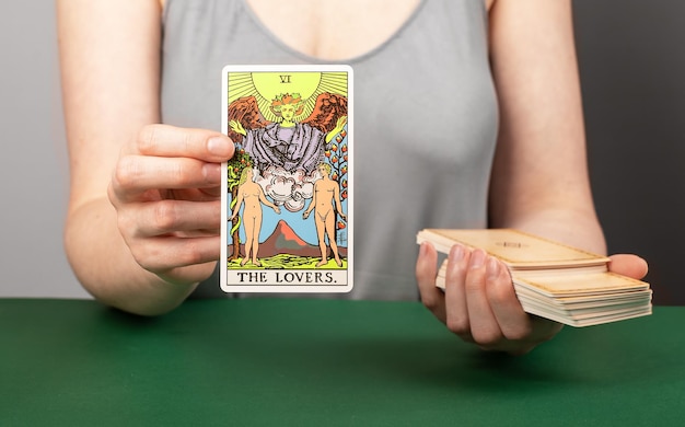 Lodz Poland April 15 2023 Lovers arcana tarot readers hand holding showing taro card during divination