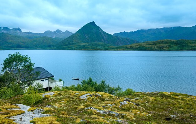 Lofoten summer cloudy view (Norway) with house on coast.