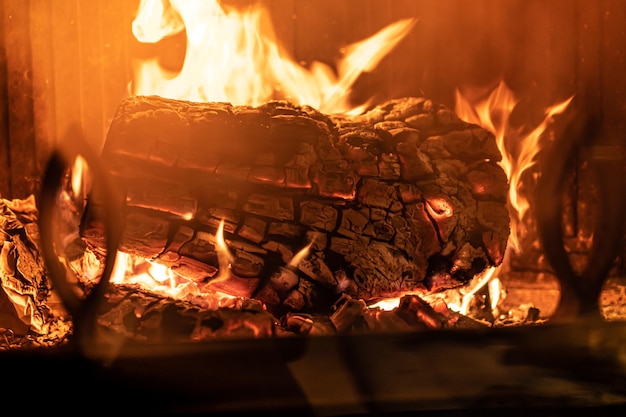 Log of wood burning in a fireplace inside a house hearth