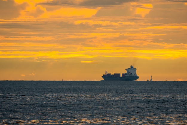 Logistics import export Container Cargo ship in seaport on sunset sky, Freight Transportation by container ship boat