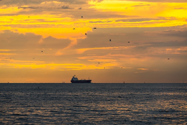 Logistics import export Container Cargo ship in seaport on sunset sky, Freight Transportation by container ship boat