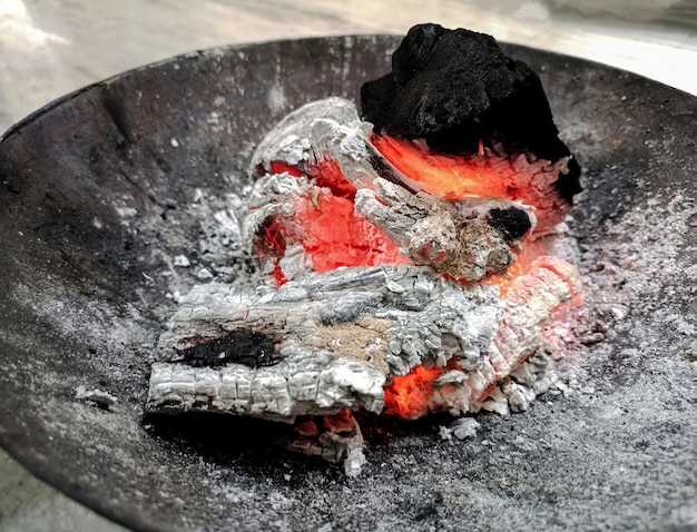 Logs burn in the campfire Closeup of firewood coals at indian village in winter