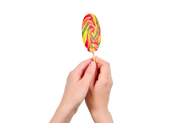 Lollipop in female hand isolated on white background Space for text or design