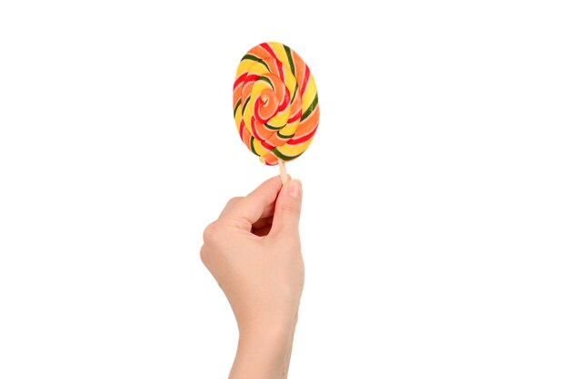 Lollipop in female hand isolated on white