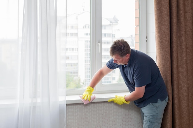 Lonely bachelor man tidies up the house before a date