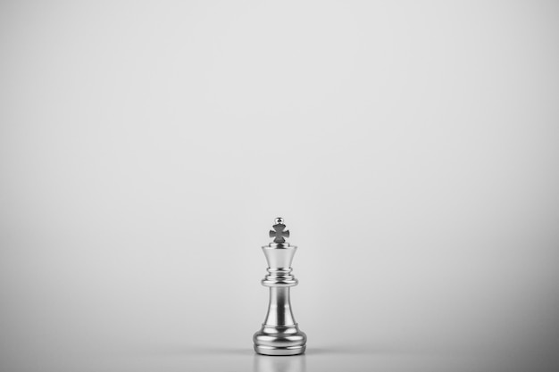 Lonely king chess standing on white background.