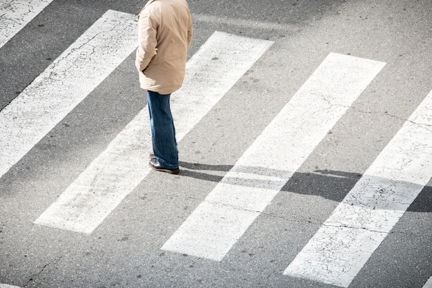 Lonely man on crosswalk