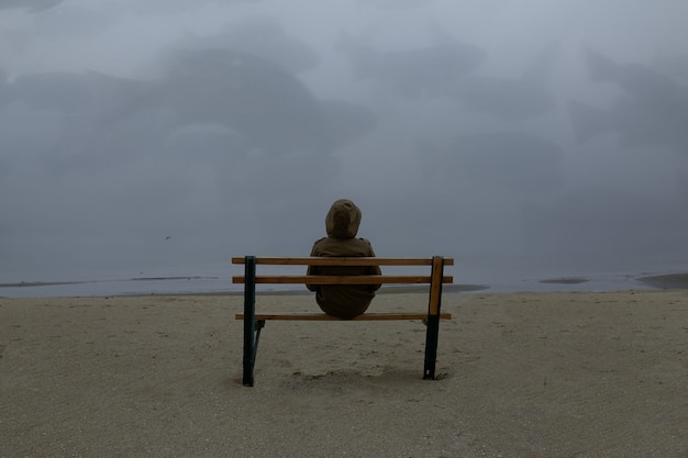 Photo lonely man walking on a foggy beach