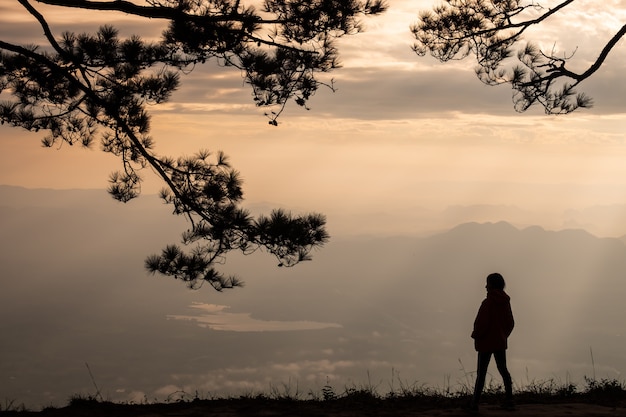 Lonely woman standing at the cliff