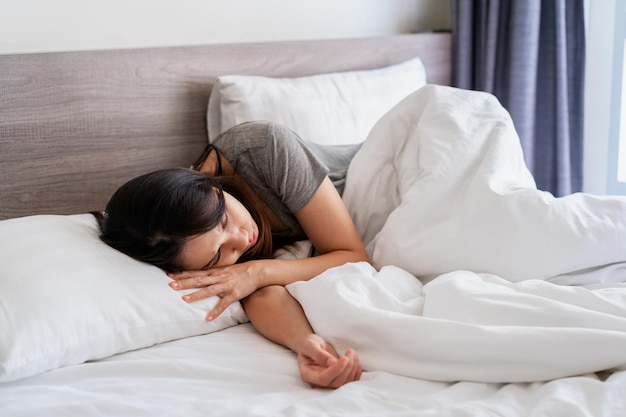 Lonely young woman feeling depressed and stressed sitting in the bedroom, Negative emotion and mental health concept