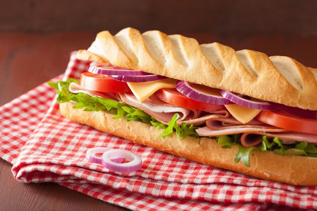 Long baguette sandwich with ham cheese tomato lettuce