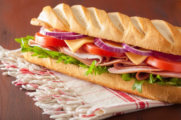 Long baguette sandwich with ham cheese tomato lettuce