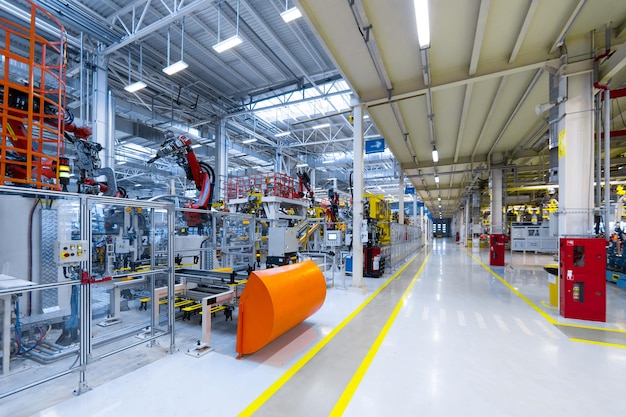 Long corridor along robots that manufacture cars latest technological neutral technologies of production of cars at plant Assembly shop for modern cars