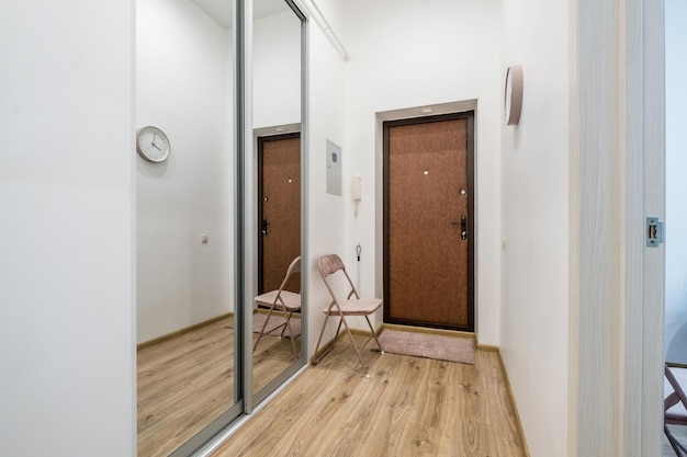 Long empty corridor in interior of entrance hall of modern apartments office or clinic with many doors