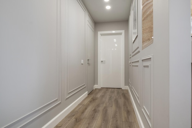 Long empty corridor in interior of entrance hall of modern apartments office or clinic