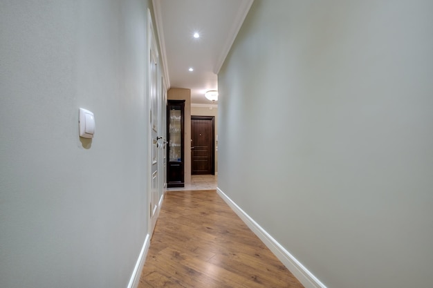 Long empty corridor in interior of entrance hall of modern apartments office or clinic