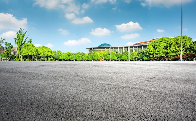 Long empty footpath in modern city square with skyline