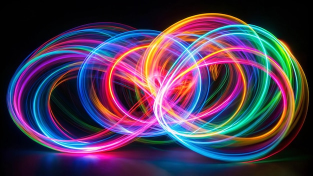 Long exposure photograph of neon multi colour loops in an abstract swirls pattern against a black background Light painting photography