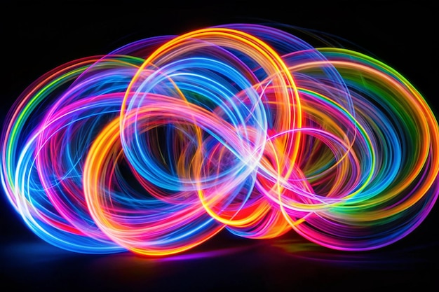 Long exposure photograph of neon multi colour loops in an abstract swirls pattern against a black background Light painting photography