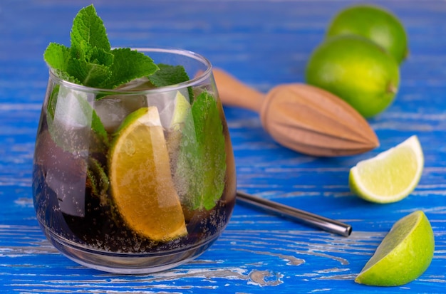 Long Island cocktail in a glass on a blue wooden background