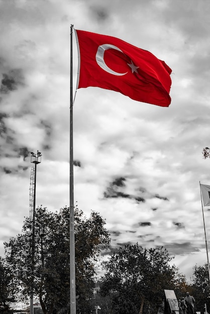 Long mast turkish flag with cloudy gray sky