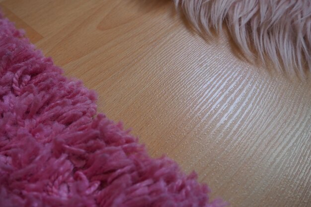 Long pile rug in pink on a beige laminate floor Feminine interior for a room or bedroom of a girl or woman Interior design in pink tones Flooring is laminate The role of dust mites in allergies