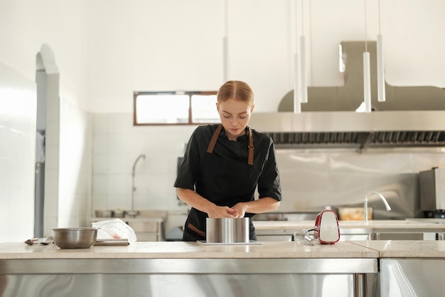 Photo a long range shot of a professional kitchen in a pastry shop pastry chef works