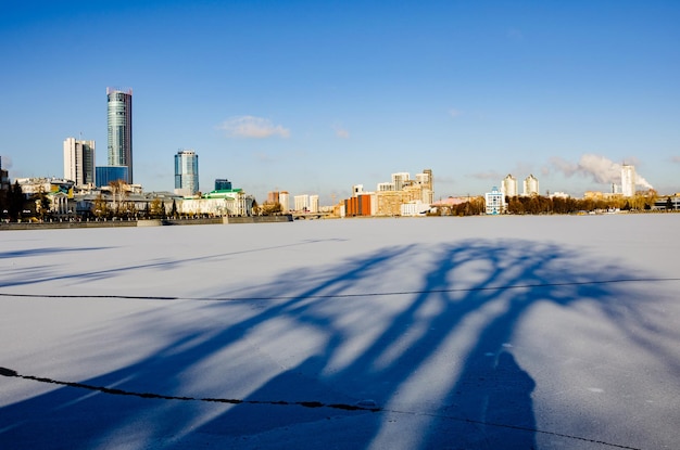 Long shadows on the ice of a frozen lake.