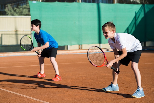 long shot kids playing double tennis