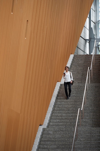 Long shot woman climbing down stairs