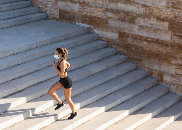 Long shot woman running on stairs