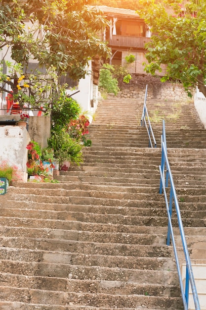 Long stone staircase leads to the beautiful houses at sunset