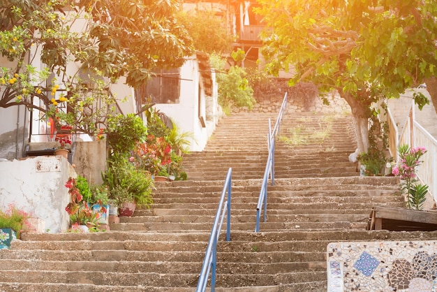 Long stone staircase leads to the beautiful houses at sunset