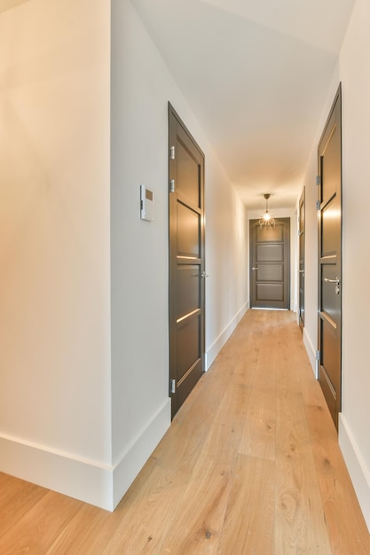 A long straight corridor with many wooden doors