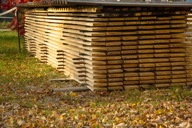 Long trim boards are properly and evenly stacked on the street. Storage. selective focus.