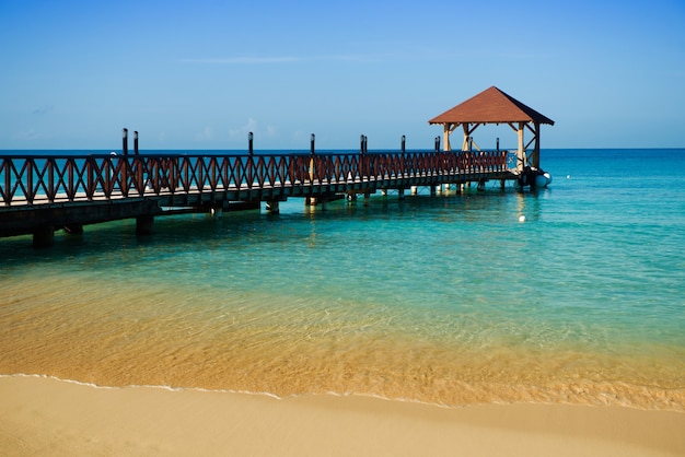 Long wooden jetty for ships, stretching into the sea