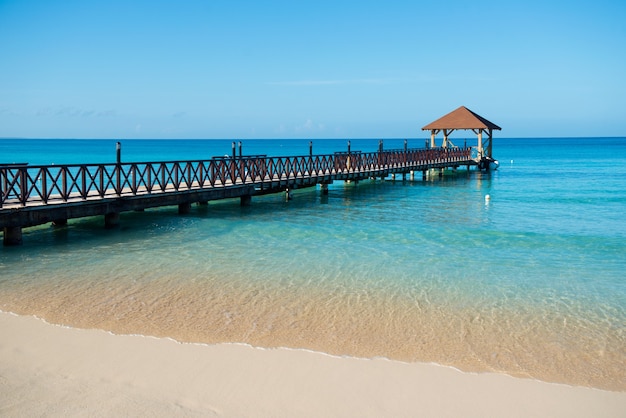 Long wooden jetty for ships, stretching into the sea