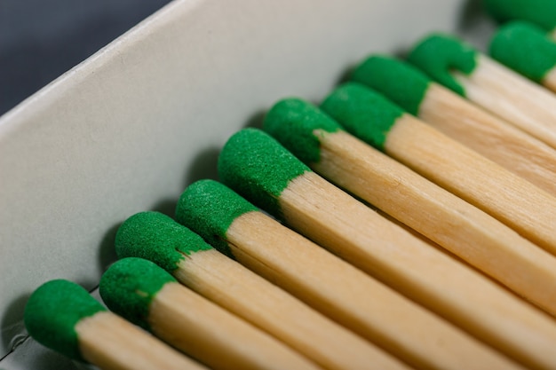 Long wooden matches with green gray in a box