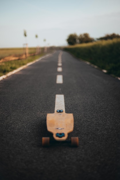 Longboard in the middle of the road without a figure copy space vertical banner poster longboard day