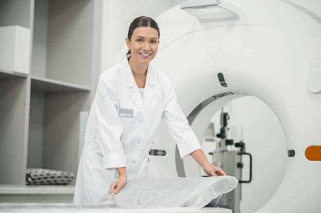 Longhaired doctor preparing MRI scanner for work