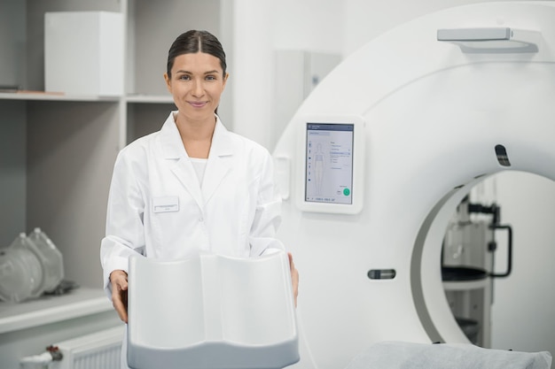 Longhaired doctor preparing MRI scanner for work