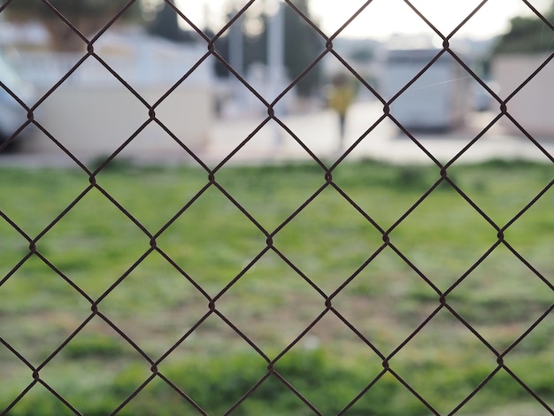 A look at the cityscape through a chainlink fence