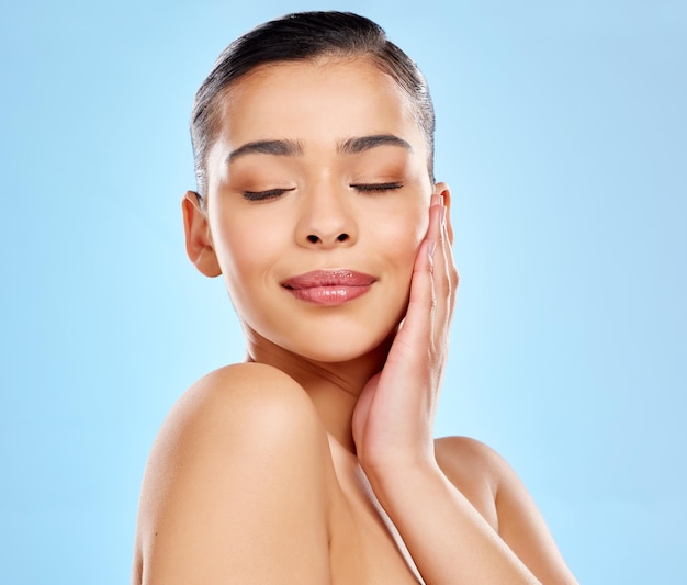 Look flawless naturally Studio shot of an attractive young woman posing against a blue background