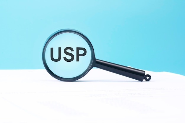 Look at the text USP through a magnifying glass on a blue and white background