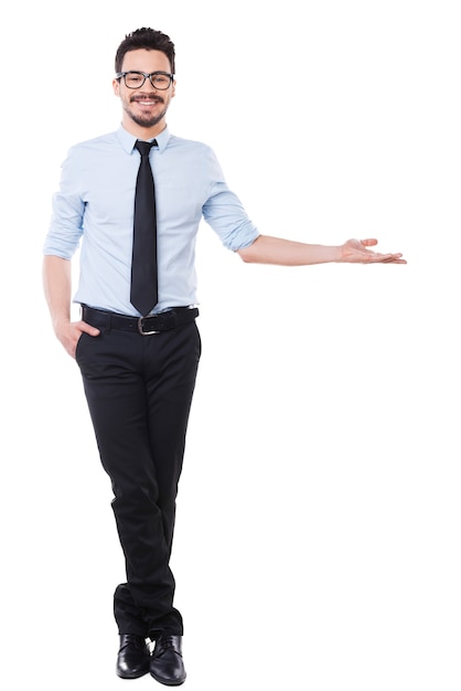 Look at that! Full length of handsome young man in shirt and tie pointing away and smiling