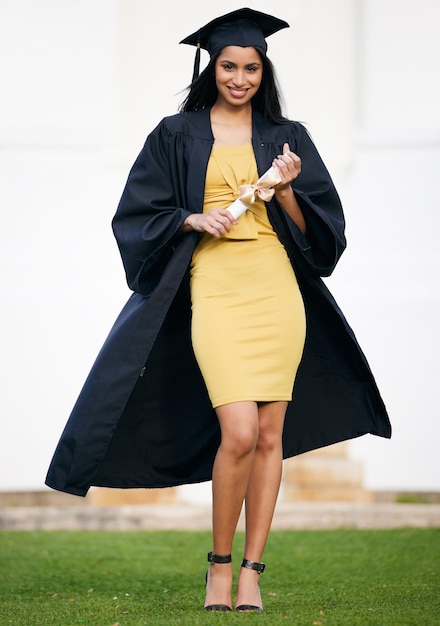 Looking glamorous on her graduation day Portrait of a young woman holding her diploma on graduation day