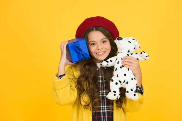 Looking good parisian girl with dog toy and present box small souvenir from france trendy little girl french beret happy birthday shopping time best day ever happy holiday greeting