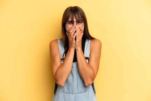 Looking happy cheerful lucky and surprised covering mouth with both hands